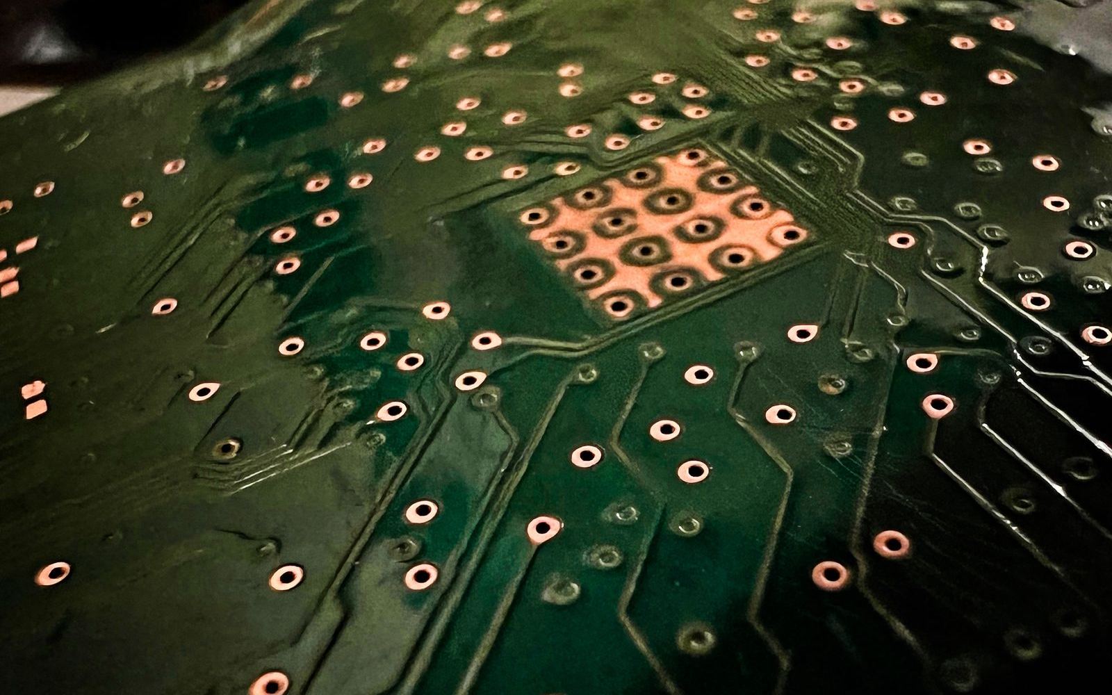 Close-up of a circuit board showing copper contacts and traces